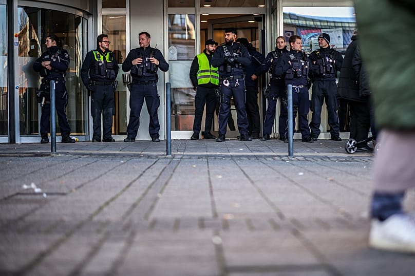 Police officers stand in front of the savings bank branch in the Buer district of Gelsenkirchen, 30 December, 2025 