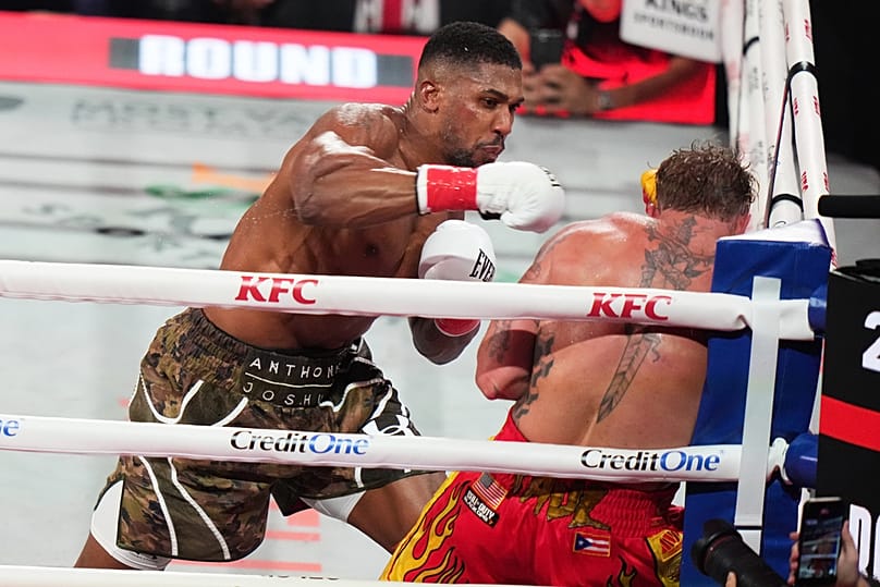 Anthony Joshua, left, and Jake Paul, right, compete during their heavyweight boxing match, Friday, Dec. 19, 2025, in Miami