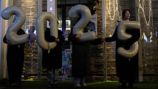 FILE - Workers hold up balloons showing 2025 as they shoot a video to welcome 2026 at a shopping district in Beijing, China, Thursday, Dec. 18, 2025. (AP Photo/Ng Han Guan)