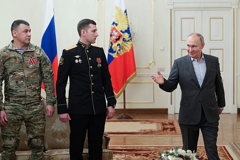Russian President Vladimir Putin gestures as he speaks to Russian servicemen participating in war in Ukraine at his residence near Moscow, 1 January 2024