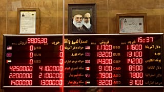 FILE - Various rates and prices for currencies and gold coins are displayed at an exchange bureau, in Tehran, Iran, Aug. 21, 2019.