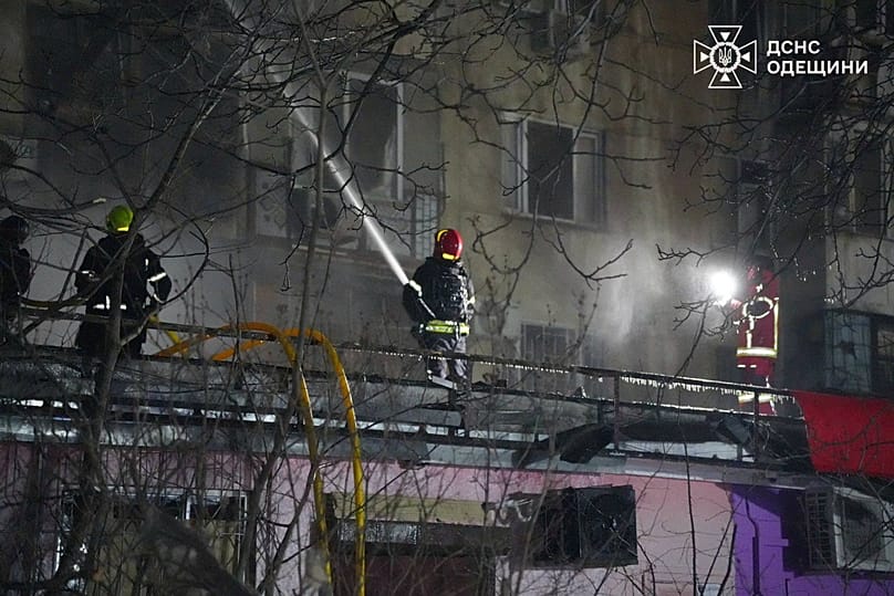 Emergency services personnel work to extinguish a fire following a Russian attack in Odesa, 31 December, 2025