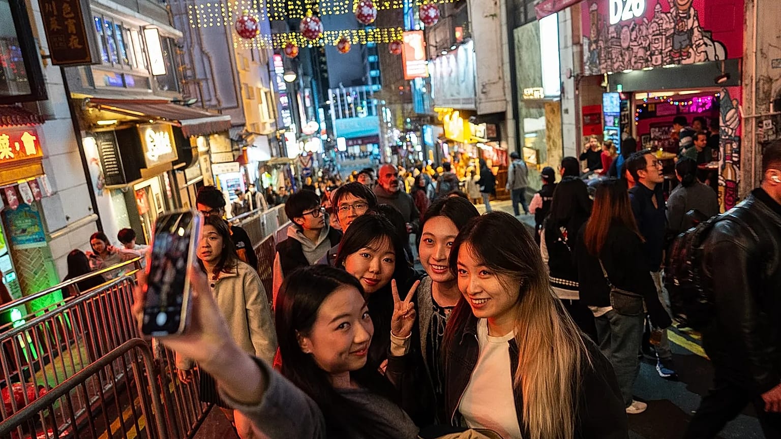 People take selfies at Lan Kwai Fong to celebrate the start of 2026 in the Central district of Hong Kong, 31 December, 2025