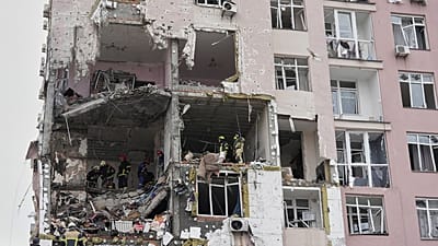 FILE: Rescuers work on the scene of a building damaged by a Russian attack in Kyiv, 27 December 2025