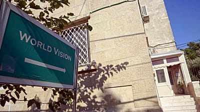 FILE: A sign shows the direction to the World Vision offices in Jerusalem, 8 August 2016