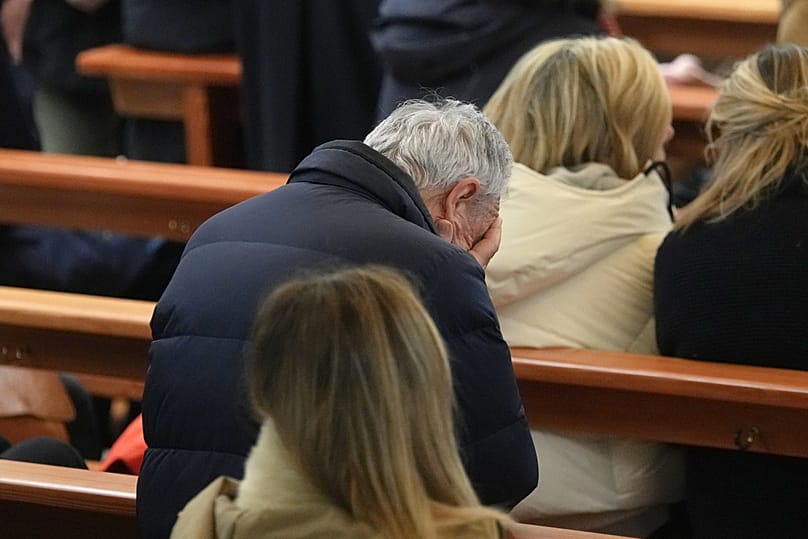 People attend a New Year mass at the catholic church of Montana Station to remember the victims of the devastating fire at the Le Constellation bar, 1 January 2025