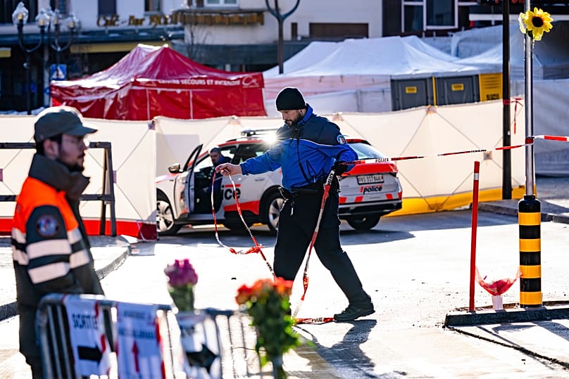 Police officers inspect the area where a fire broke out at the Le Constellation bar and lounge during New Year's celebration, in Crans-Montana, 1 January 2026