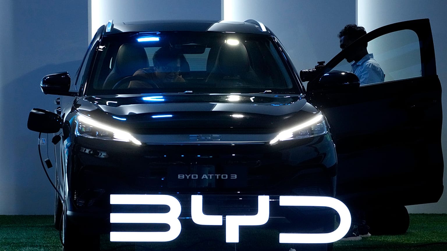 FILE - Journalists inspect a BYD Atto 3 displayed during its launch event in Jakarta, Indonesia. 18 January 2024. 