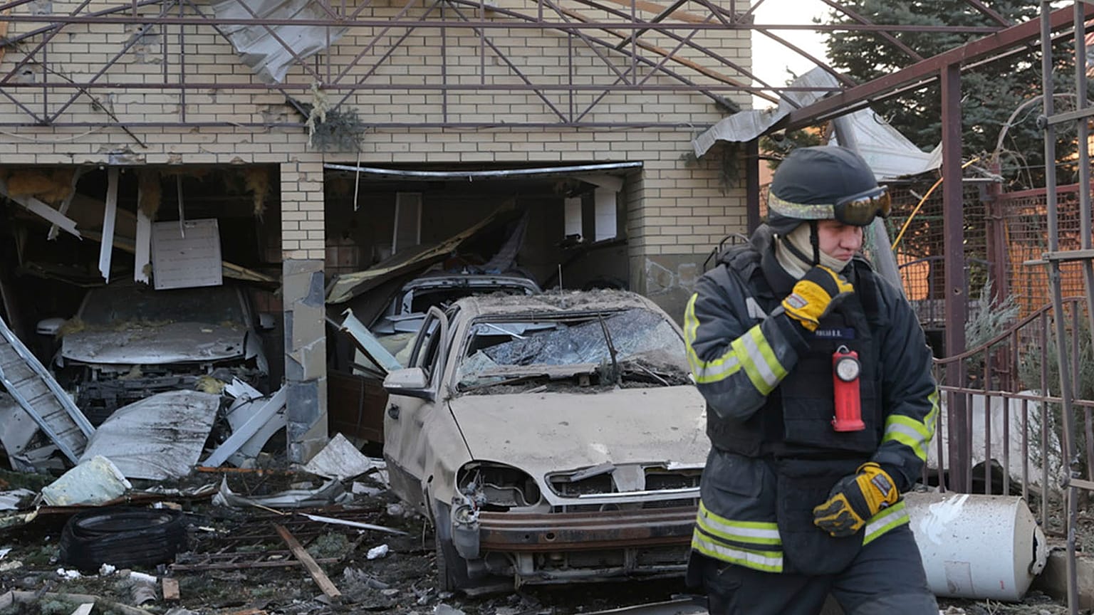 FILE: A rescue worker walks in front of a residential house damaged after a Russian attack on Zaporizhzhia, 19 December 2025