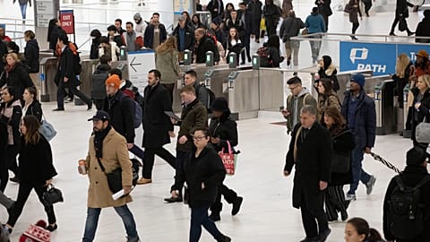 Commuters walk from the PATH rapid transit station into the World Trade Center in New York on Nov. 18, 2019. 