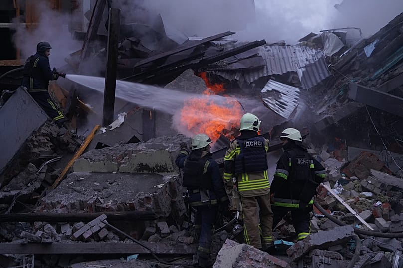 Emergency services personnel work to extinguish a fire following a Russian missile attack in Kharkiv, 2 January, 2026