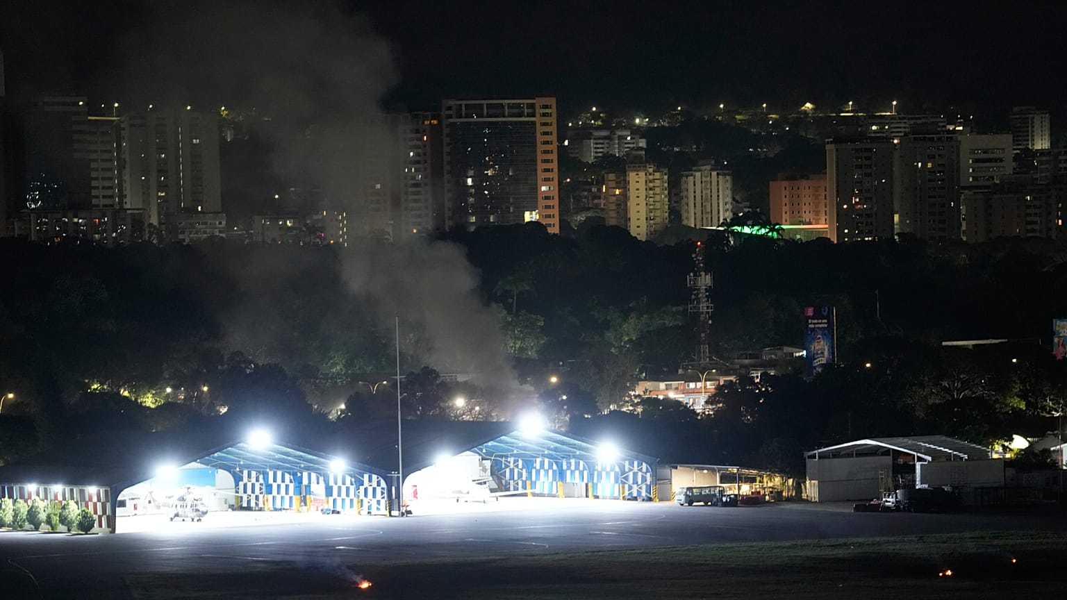 Smoke raises at La Carlota airport after explosions and low-flying aircraft were heard in Caracas, Venezuela, Saturday, Jan. 3, 2026.