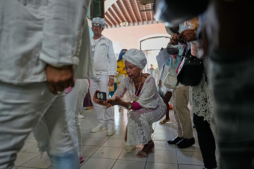 A woman records a video of Santería followers performing a holy drum beat after the reading of the Letter of the Year in Havana, Cuba, 2 January 2026