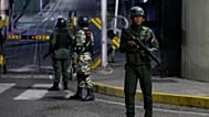 Soldiers guard the area around the Miraflores presidential palace after explosions and low-flying aircraft were heard in Caracas, 3 January 2026