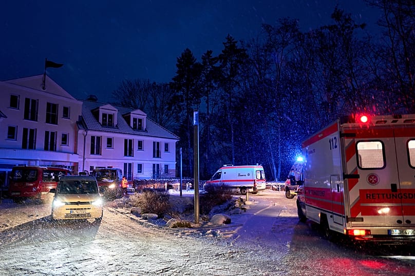 Emergency vehicles from the aid organization "Die Johanniter" pick up residents of a retirement home in Berlin, Germany, Saturday, Jan. 3, 2025, during a power cut.