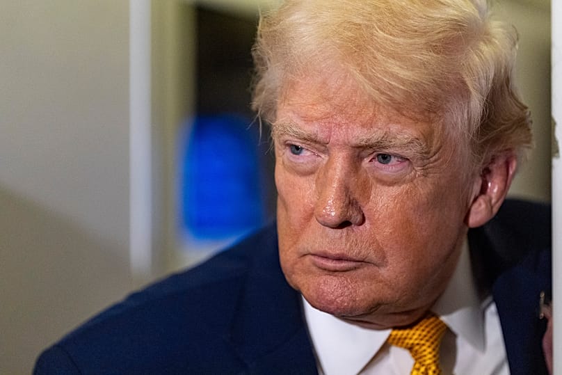 US President Donald Trump speaks with reporters while in flight on Air Force One, 4 January, 2026