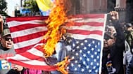 Government supporters burn a US flag after Trump announced that US forces had captured Venezuelan President Maduro and his wife, in Caracas, Venezuela, Saturday, Jan. 3, 2026