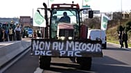 A French farmer drives his tractor to block a main road during a protest against the Mercosur trade deal with South American nations, December 2025
