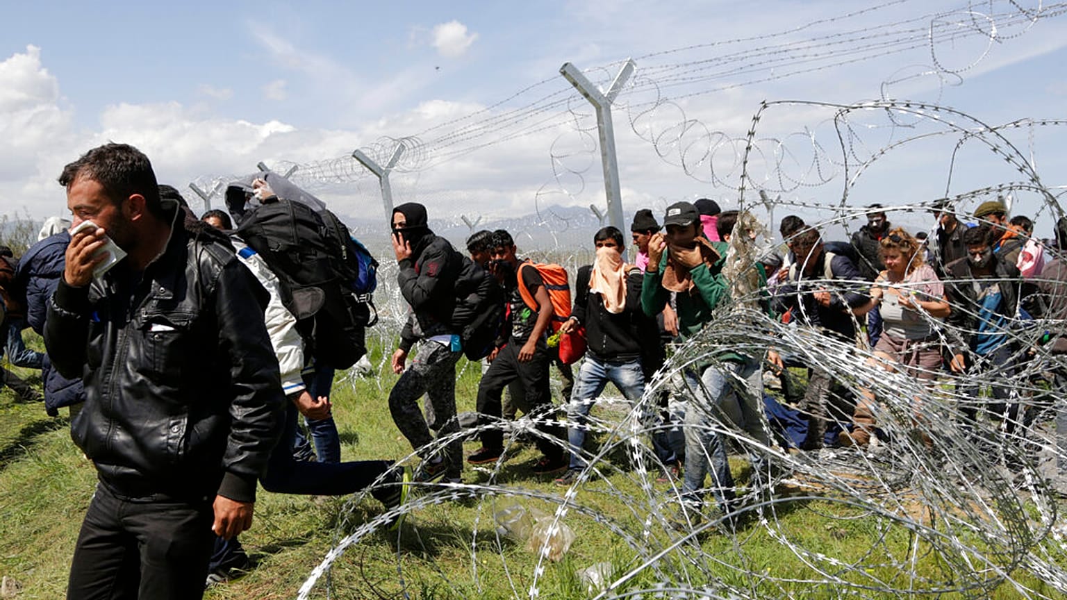 Migrants walk to a registration and transit camp after entering Macedonia from Greece near the southern Macedonian town of Gevgelija, Sunday, March 6, 2016. 