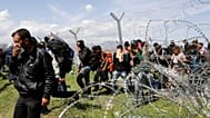 Migrants walk to a registration and transit camp after entering Macedonia from Greece near the southern Macedonian town of Gevgelija, Sunday, March 6, 2016. 
