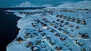 Houses covered by snow are seen on the coast of a sea inlet at Nuuk, 7 March, 2025