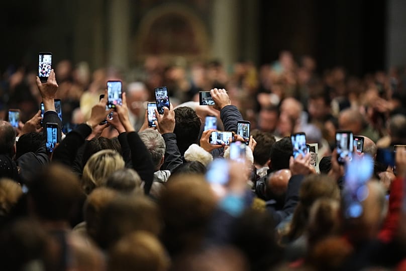 People take photos of Pope Leo XIV as he arrives to celebrate Mass on the Day of the Epiphany of the Lord inside St. Peter's Basilica at the Vatican, 6 January, 2026