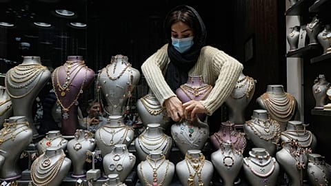 FILE. A goldsmith arranges necklaces at the window of a gold shop at a gold market in Tehran's Grand Bazaar, Iran. 29 Nov. 2025