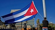 Workers fly the Cuban flag at half-mast in Havana, Cuba, Monday, Jan. 5, 2026, in memory of Cubans who died two days before in Caracas, Venezuela.