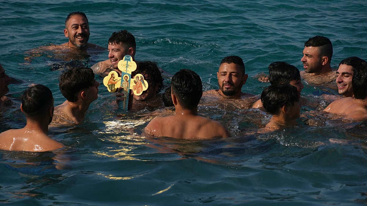 Young men in Greece dive for wooden cross in Epiphany celebration