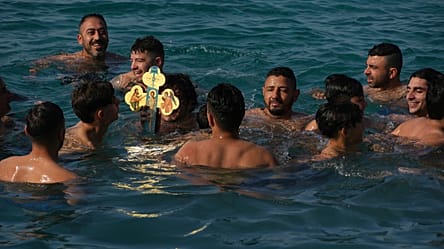 Young men in Greece dive for wooden cross in Epiphany celebration