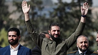 O presidente interino da Síria, Ahmad al-Sharaa, cumprimenta as pessoas enquanto participa nas celebrações que assinalam o primeiro aniversário da destituição de Bashar al-Assad em Damasco, 8 de dezembro de 2025