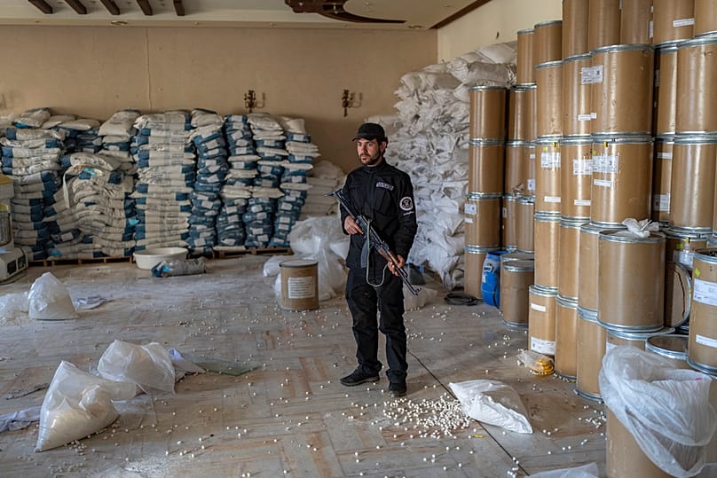Members of the Syrian security forces inspect a lab where captagon pills were manufactured before the fall of Bashar al-Assad government, outskirts of Damascus, 7 January 2025
