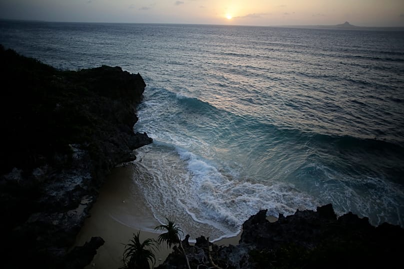 In this Wednesday, Sept. 18, 2013 photo, the sun goes down at the sea in Motobu, on the southern island of Okinawa, Japan.