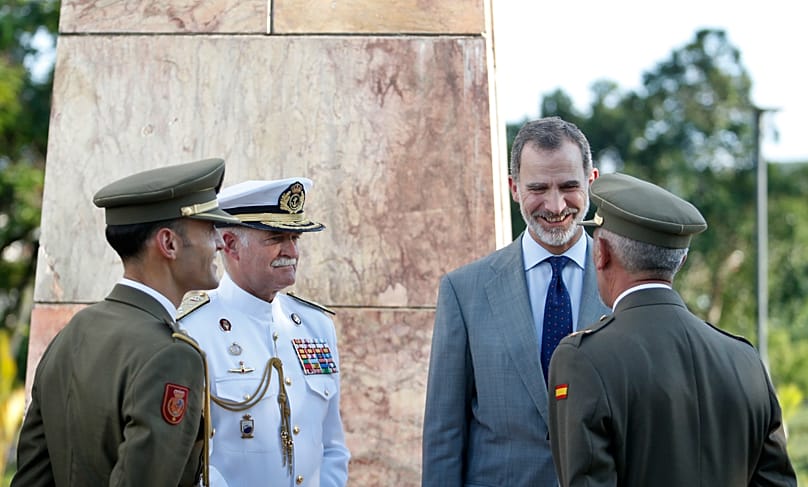 Spain's King Felipe chats with Spanish officers as he visits a monument for Spanish soldiers that died during the Spanish-American war in Santiago, Cuba, Nov. 14, 2019.