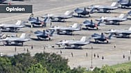 US F-35 fighter jets are parked on the tarmac as military personnel walk among the aircraft at José Aponte de la Torre Airport in Ceiba, Puerto Rico, 3 January 2026