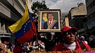 A government supporter holds an image of President Nicolás Maduro during a women's march to demand his return in Caracas, 6 January, 2026
