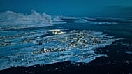 Houses covered by snow are seen on the coast of a sea inlet of Nuuk, 7 March, 2025