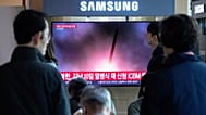 A TV screen shows a file image of North Korea's missile launch during a news programme at Seoul Railway Station, 22 October, 2025