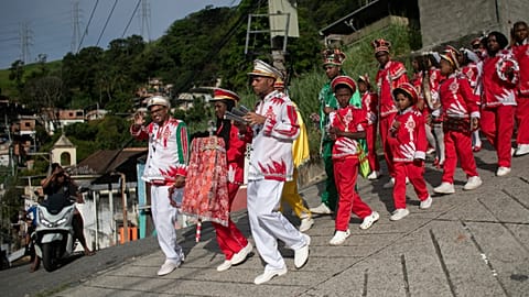 The Bright Star of Bethlehem group parade through a street during a Three Kings Day celebration,