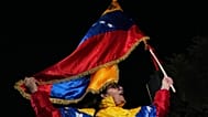 FILE: A demonstrator waves a Venezuelan flag at a protest against US strikes on Venezuela, outside the US embassy in Nicosia, 5 January 2025
