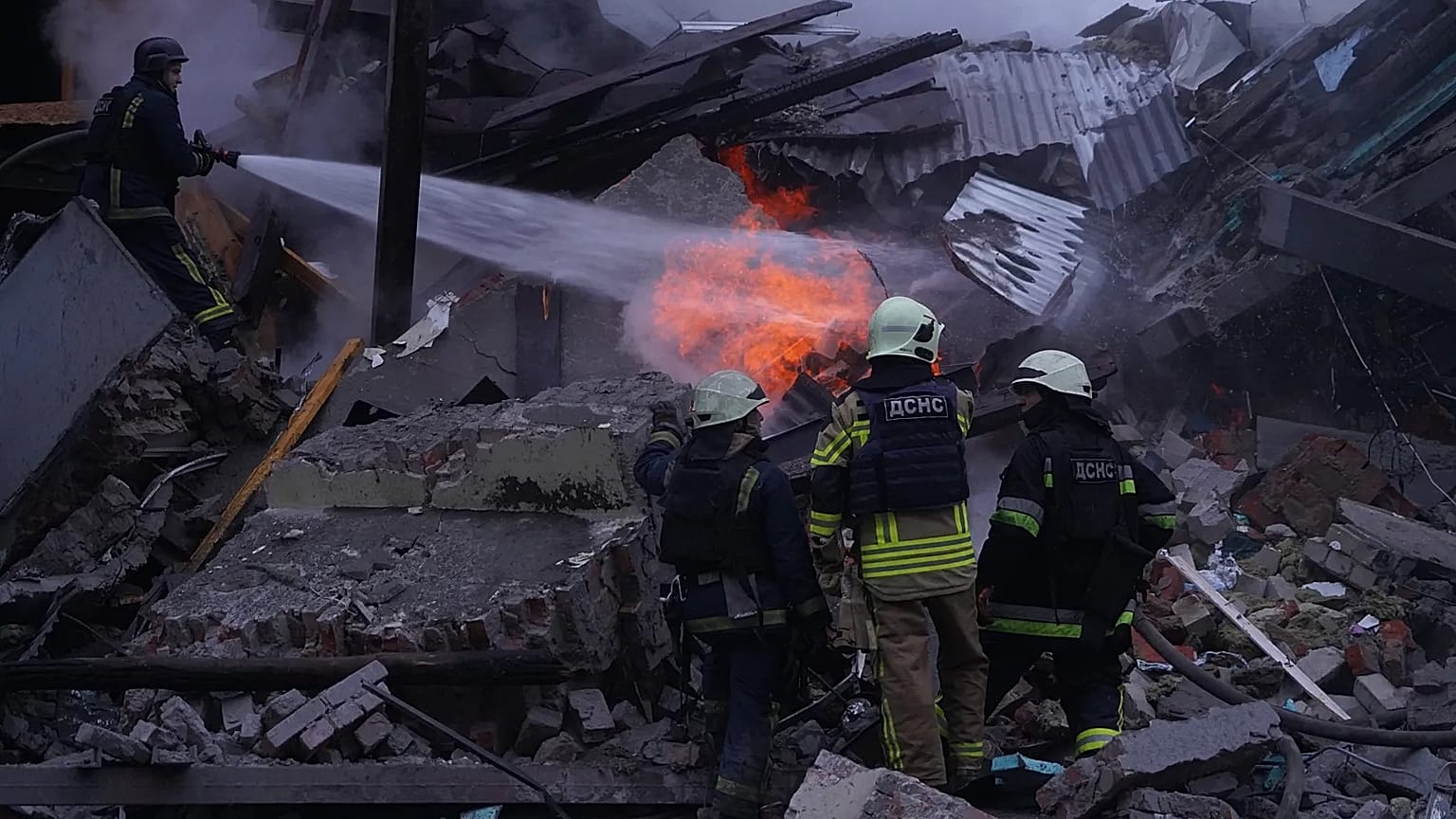 Emergency services personnel work to extinguish a fire following a Russian missile attack in Kharkiv, 2 January, 2026