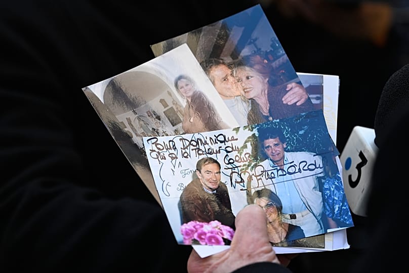 A guest arrives with photographs of Brigitte Bardot at Notre-Dame de l'Assomption church in Saint-Tropez, 7 January, 2026 