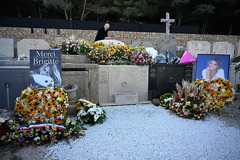 A man takes a photograph of actor Brigitte Bardot's tomb in the Saint-Tropez cemetery, 7 January, 2026