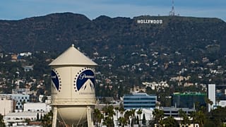 FILE. The Paramount Pictures water tower is seen in Los Angeles, with the Hollywood sign in the distance. 18 Dec. 2025.