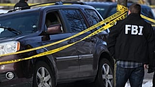 A bullet hole is seen in the windshield as law enforcement officers work the scene of a shooting involving federal law enforcement agents, Wednesday, Jan. 7, 2026, in Minneapo