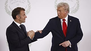 FILE: US President Donald Trump and French President Emmanuel Macron shake hands at the Gaza International Peace Summit, in Sharm el-Sheikh, 13 October 2025