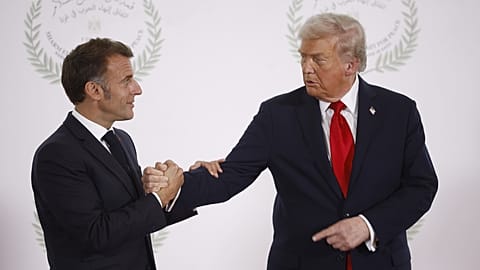 FILE: US President Donald Trump and French President Emmanuel Macron shake hands at the Gaza International Peace Summit, in Sharm el-Sheikh, 13 October 2025