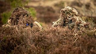 FILE: Danish soldiers from the Schleswig Infantry Regiment in camouflage train at the Oksboel Shooting and Training Ground, Jutland, 16 March 2023
