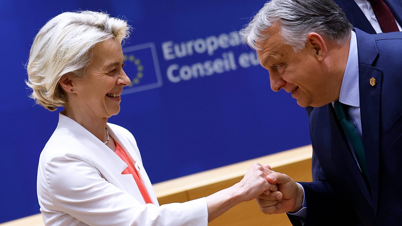 European Commission President Ursula von der Leyen, left, is greeted by Hungary's Prime Minister Viktor Orban during a round table meeting at an EU summit in Brussels, June 17