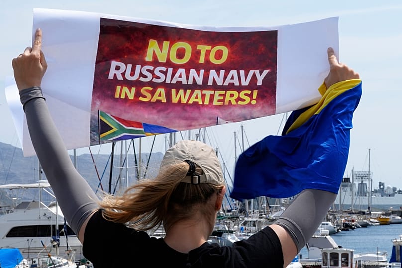 A protester demonstrates against Russia's naval presence in Simon's Town Harbour in Cape Town, 9 January, 2026